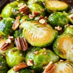 - 1.5 lbs Brussels sprouts, trimmed and halved - 3 tablespoons maple syrup - 2 tablespoons olive oil - 1 teaspoon garlic powder - 1 teaspoon salt - ½ teaspoon black pepper - ½ cup pecans, roughly chopped (optional) - 1 tablespoon balsamic vinegar (optional) When I make maple roasted Brussels sprouts, I love using fresh, vibrant Brussels sprouts. They have a sweet, nutty taste that pairs perfectly with maple syrup. The maple syrup adds a lovely sweetness that balances the slight bitterness of the sprouts. Olive oil is essential here. It helps in roasting and gives a nice, rich flavor. Garlic powder adds depth, while salt and pepper enhance the natural taste. If you want some crunch, add pecans. They bring a great texture and flavor. I sometimes drizzle balsamic vinegar at the end for a tangy twist. - Baking sheet - Large mixing bowl - Measuring spoons - Knife and cutting board For this recipe, you need a few simple tools. A baking sheet helps with even roasting. A large mixing bowl makes it easy to combine everything. Measuring spoons ensure you get the right amounts. Finally, a knife and cutting board are needed to trim the Brussels sprouts. With these ingredients and tools, you're all set to create a delicious dish. You can check out the [Full Recipe] for step-by-step instructions. Enjoy your cooking adventure! - Preheat your oven to 400°F (200°C). - Trim and halve the Brussels sprouts. This helps them cook evenly and taste great. - In a large mixing bowl, mix Brussels sprouts with olive oil, maple syrup, garlic powder, salt, and pepper. Make sure every sprout gets a nice coat. This mixture adds sweetness and flavor. - Spread the sprouts in a single layer on a baking sheet. This step is key for good roasting. - Roast for 20-25 minutes, shaking the pan halfway. This helps them brown evenly. You want them golden and crispy on the edges. For extra crunch, sprinkle chopped pecans during the last five minutes. You can find the full recipe [here](#). To get crispy Brussels sprouts, spread them out on the baking sheet. Make sure they are in a single layer. This helps them roast evenly. Shake the pan halfway through cooking. This allows hot air to reach all sides. You can add balsamic vinegar for a bit of tang. It gives a nice balance to the sweetness of the maple. Garlic adds depth, too. You can also try spices like paprika or cayenne for extra heat. This way, you can customize the flavors to your taste. These Brussels sprouts go well with proteins like chicken or fish. They make a great side dish. You can also serve them as a healthy snack or appetizer. They are delicious warm or at room temperature. For more ideas, check out the Full Recipe. {{image_2}} You can easily make this dish nut-free. Just omit the pecans. The Brussels sprouts will still taste great with the maple syrup and spices. You won't miss the nuts at all! If you want a vegan version, you can keep it simple. Use maple syrup as your only sweetener. This recipe already has olive oil, so it’s vegan-friendly. Just make sure to check your balsamic vinegar for any added ingredients that aren’t vegan. Want to make your Brussels sprouts special for the season? Add some seasonal spices! A sprinkle of cinnamon or nutmeg gives a warm, festive touch. This twist makes your dish stand out and adds a new flavor layer. Try it next time for a fun change! For the full recipe, check out the [Full Recipe]. Store leftovers in an airtight container in the fridge. Make sure the sprouts cool down first. This keeps them fresh and tasty for your next meal. Reheat in the oven for best texture. Set the oven to 350°F (175°C) and warm for about 10 minutes. If you're in a hurry, you can use the microwave. Heat them for 1-2 minutes, checking often to avoid overcooking. These delicious Brussels sprouts last for up to 3 days in the fridge. If you freeze them, the texture can change, making them mushy. For the best quality, enjoy them fresh or stored in the fridge. Yes, but fresh is recommended for better texture. Frozen Brussels sprouts often lose their crunch. They may also release more water, making them less crispy. If you use frozen ones, be sure to thaw and drain them first. All ingredients are naturally gluten-free; ensure seasonings are free of gluten. Check labels on packaged items. Some sauces or spices may contain hidden gluten. Using fresh ingredients helps keep this dish safe for gluten-free diets. Honey or agave can be used as a replacement, though it will alter flavor. Maple syrup provides a unique taste that is hard to match. If you choose honey, use a little less, as it is sweeter. Agave has a milder flavor and can work well, too. This recipe shows you how to make tasty roasted Brussels sprouts. You need simple ingredients and basic tools. Preheat your oven, mix the sprouts, and roast them for a perfect dish. Remember to try different flavors and store any leftovers properly. These sprouts pair well with any meal or stand alone as a snack. Enjoy trying this recipe and make it your own! Happy cooking!