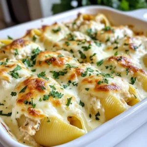 - 12 large jumbo pasta shells - 2 cups cooked chicken, shredded - 1 cup ricotta cheese - 1 cup mozzarella cheese, shredded - 1/2 cup Parmesan cheese, grated For this dish, the jumbo pasta shells are key. They hold a lot of filling and create a perfect bite. I use cooked chicken that I shred myself. It adds great flavor and makes this dish hearty. Cheese is essential here. I like to use a mix of ricotta, mozzarella, and Parmesan. The ricotta gives it a creamy texture. Mozzarella melts well, and Parmesan adds a salty kick. - 1 teaspoon garlic powder - 1 teaspoon Italian seasoning - 2 cups Alfredo sauce (store-bought or homemade) Seasoning is vital for flavor. I use garlic powder and Italian seasoning to enhance the dish. They add depth and make it taste amazing. For the sauce, I often go with Alfredo. You can use store-bought or make your own. Both work well, but homemade can take it to the next level. - Fresh parsley - Alternative garnish options Garnish is not just for looks; it adds flavor. I like to use fresh parsley for a pop of color and taste. You can also try other options like basil or even a sprinkle of extra cheese. {{ingredient_image_1}} 1. Preheat your oven to 350°F (175°C). This step warms the oven and helps cook the shells evenly. 2. Cook the jumbo pasta shells in a large pot of salted boiling water. Follow the package instructions until they are al dente. Drain the shells and set them aside to cool slightly. 1. In a mixing bowl, combine the shredded chicken, ricotta cheese, 1/2 cup of mozzarella cheese, 1/4 cup of Parmesan cheese, garlic powder, Italian seasoning, salt, and pepper. Mix these ingredients well until they are fully combined. 2. Now, take each cooked pasta shell and carefully stuff it with the chicken and cheese mixture. Place them seam-side up in a baking dish. 1. Spread 1 cup of Alfredo sauce evenly over the bottom of a 9x13 inch baking dish. This keeps the shells moist. 2. Pour the remaining Alfredo sauce over the stuffed shells. Make sure to cover them generously. 3. Sprinkle the top with the remaining mozzarella and Parmesan cheese. This will create a nice golden crust. 4. Cover the dish with aluminum foil and bake in the preheated oven for 25 minutes. 5. After 25 minutes, remove the foil and bake for an additional 10-15 minutes. The cheese should be melted and bubbly. 6. Once baked, take the dish out of the oven and let it cool for a few minutes. Garnish with fresh parsley before serving. To ensure perfect pasta texture, cook the jumbo shells until they are al dente. This means they should be firm yet tender. Overcooking can lead to soggy shells. After cooking, drain them and let them cool slightly to make stuffing easier. If you have leftover chicken, use it! Shred it up and mix it with the cheese. This makes a great filling. You can also use rotisserie chicken to save time. Just make sure to remove any skin before shredding. For plating, arrange the stuffed shells in a nice row. Drizzle extra Alfredo sauce on top for a beautiful look. You can also serve them on a bed of fresh spinach or arugula for color. Garnish with fresh parsley. It adds a nice touch of green and freshness. You could also sprinkle some additional Parmesan cheese for extra flavor. Using store-bought ingredients can save you time. You can buy pre-made Alfredo sauce and rotisserie chicken. This makes your cooking process quicker and easier. For time-saving methods, try cooking the shells while you prepare the filling. This way, you save time and keep the meal moving. Also, you can bake the stuffed shells while you set the table, making everything more efficient. Pro Tips Cook Pasta Al Dente: Make sure to cook the jumbo shells just until al dente. They will continue to cook in the oven, preventing them from becoming mushy. Use Rotisserie Chicken: For a quicker option, use store-bought rotisserie chicken to save time on cooking and shredding. Customize Your Cheese: Feel free to experiment with different types of cheese, such as gouda or fontina, for a unique flavor twist. Add Vegetables: Incorporate some sautéed spinach or mushrooms into the filling for added nutrition and flavor. {{image_2}} You can make Chicken Alfredo Stuffed Shells even better by adding vegetables. Spinach, mushrooms, and bell peppers work great. Just sauté them first to soften. Mix them into the filling for extra taste and nutrition. You can also change the cheese. Instead of just mozzarella, try gouda or fontina. These cheeses melt well and add a unique flavor. Mixing cheeses can make your dish more exciting and delicious. If you need a gluten-free option, use gluten-free jumbo pasta shells. Many brands now offer this choice. Just cook them according to package directions. Your stuffed shells will still taste great! For a vegetarian version, skip the chicken. Use more cheese or add beans for protein. You could also add roasted vegetables. This keeps the dish hearty and satisfying without meat. You can swap the Alfredo sauce for a white sauce. A simple béchamel can give a nice twist to the dish. It’s creamy and still delicious. If you like heat, try a spicy Alfredo. Add red pepper flakes to the sauce. This gives the dish a kick and makes it more interesting. To store your stuffed shells, place them in an airtight container. Make sure the dish is cooled down before you cover it. This keeps the flavors fresh. You can store them in the fridge for about 3 to 4 days. If you want to enjoy them later, it's best to eat them fresh. You can freeze stuffed shells either before or after baking. If you freeze them before baking, wrap the dish tightly with plastic wrap and then foil. This helps keep out air. For freezing after baking, let them cool first, then cover well. They last up to 3 months in the freezer. To thaw, place them in the fridge overnight. Heat them in the oven at 350°F until warm. Cover with foil to keep moisture in. Leftover Chicken Alfredo Stuffed Shells are great for quick meals. You can chop them up in a salad or mix them in a pasta bake. For reheating, use the oven to keep the shells nice and creamy. Place them in a baking dish and cover with foil. Heat at 350°F until heated through. This helps keep the texture just right. Can I make Chicken Alfredo Stuffed Shells ahead of time? Yes, you can prepare these stuffed shells in advance. Just fill the shells and layer them with sauce. Cover and store them in the fridge for up to 24 hours. When ready, bake them straight from the fridge. You may need to add a few extra minutes to the baking time. What can I substitute for ricotta cheese? If you don’t have ricotta cheese, try using cottage cheese. You can blend it to make it smooth. Cream cheese is also a great option for a richer taste. Just make sure to adjust the amount to keep the texture right. Can I use different pasta shapes? You can use other pasta shapes if you prefer. Manicotti or cannelloni work well too. Just ensure they are large enough to hold the filling. Cooking times may vary, so check the package instructions. How do I know when the stuffed shells are done? Stuffed shells are done when the cheese on top is melted and bubbly. The edges should be slightly golden. You can also check the center with a fork to ensure it is hot throughout. Can I use homemade Alfredo sauce? Absolutely! Homemade Alfredo sauce adds a nice touch. Just make sure it’s creamy and well-seasoned. It will enhance the flavor of the stuffed shells. What are the best brands for store-bought Alfredo sauce? Some popular brands for store-bought Alfredo sauce include Bertolli, Classico, and Rao’s. Choose a brand that you enjoy. Look for sauces with natural ingredients for the best taste. This blog has guided you through making Chicken Alfredo Stuffed Shells. We covered key ingredients, step-by-step instructions, and useful tips for success. You now have ways to customize your dish and store leftovers. As you cook, remember to have fun and get creative. Enjoy each bite you share with family or friends. These stuffed shells can be a hit at any meal. You have all the tools to make it great!