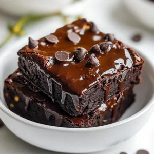 Black beans are the star of these brownies. They add moisture and richness. They also boost protein and fiber. This makes your dessert a bit healthier. Using one can (15 oz) rinsed and drained gives a perfect base. You won’t taste the beans at all. Instead, they create a dense and fudgy texture. They make these brownies unique and fun! I often use almond butter, but you can swap it out. Peanut butter works well, adding a nutty flavor. Sunflower seed butter is a good choice for nut allergies. Each option slightly changes the taste, but they all keep the brownies moist. Use 1/2 cup of any nut or seed butter. Just ensure it's smooth for the best texture. Maple syrup is my favorite sweetener for these brownies. It adds a rich flavor that pairs well with chocolate. You can use agave syrup or brown rice syrup instead. These alternatives keep the brownies vegan and sweet. Use 1/4 cup of your chosen sweetener. Adjust to your taste if you prefer a sweeter treat. {{ingredient_image_1}} First, set your oven to 350°F (175°C). This helps the brownies bake evenly. Next, grab an 8x8 inch baking pan. Line it with parchment paper. Leave some paper hanging over the edges. This makes it easy to lift the brownies out later. Now, it’s time to make the brownie base. In a food processor, mix the black beans, almond butter, maple syrup, cocoa powder, and vanilla extract. Blend until the mixture turns smooth and creamy. You may need to stop and scrape down the sides. This ensures everything gets mixed well. Once your base is smooth, add the baking powder, salt, and almond milk. Blend again. The goal is to create a fudgy, dark mixture. It should feel thick but smooth. This is where the magic happens! To get that perfect fudgy texture, start with the right beans. Use a can of black beans, rinse them well, and drain them. This step removes extra salt and helps the brownies stay moist. Blend the beans with almond butter, maple syrup, and cocoa powder until smooth. A smooth mix adds to the fudginess. When you bake them, leave a few moist crumbs on the toothpick. This keeps the brownies soft and chewy. Overmixing can ruin your brownies. Blend the batter until smooth, but don’t go too far. After adding the baking powder and almond milk, mix just until everything is combined. When you fold in the chocolate chips, use a spatula gently. This keeps the batter airy. Air helps the brownies rise and stay light. To boost the chocolate flavor, use high-quality cocoa powder. Choose a brand that you enjoy eating. Adding extra vegan chocolate chips on top gives a great melt-in-your-mouth experience. Consider mixing in a splash of espresso or strong coffee to deepen the chocolate taste. This trick works wonders to elevate the flavor, making your brownies even more delicious. Pro Tips Use Fresh Ingredients: Ensure your black beans are fresh and well-rinsed to avoid any canning residue that may affect the flavor. Adjust Sweetness: Depending on your taste preference, feel free to adjust the amount of maple syrup to make the brownies sweeter or less sweet. Experiment with Nut Butters: Try different nut or seed butters like cashew or sunflower seed butter for varied flavor profiles. Storage Tips: Store leftovers in an airtight container at room temperature for up to 3 days or in the fridge for up to a week for maximum freshness. {{image_2}} These brownies are naturally gluten-free. Black beans replace flour. They give a rich, fudgy texture. You do not need to worry about gluten at all. Just make sure your chocolate chips are also gluten-free. You can add nuts for crunch. Walnuts or pecans work great. Spices like cinnamon or nutmeg add warmth. You can also mix in fruits like chopped bananas or berries. These will bring new flavors and textures. Maple syrup gives a nice sweetness. You can use agave syrup for a lighter taste. Honey is another option if you are not strictly vegan. Adjust the amount to meet your sweet tooth. Each sweetener can change the flavor just a bit. Experiment and find what you like best! To keep your Vegan Fudgy Black Bean Brownies fresh, store them in an airtight container. Place parchment paper between layers to prevent sticking. Keep them at room temperature for up to three days. For longer storage, refrigerate them for up to a week. If you want to keep them even longer, freezing is a great option. Freezing brownies is simple. First, cut them into squares. Wrap each piece tightly in plastic wrap. Then, place the wrapped brownies in a freezer-safe bag. Label the bag with the date. You can freeze them for up to three months. When you’re ready to enjoy them, just take out a piece and let it thaw at room temperature. To reheat your brownies, place them on a microwave-safe plate. Heat for about 10-15 seconds. Check to see if they are warm enough. If you want a softer texture, add a small drizzle of almond milk before heating. This tip helps to keep them fudgy and delicious. Enjoy your brownies warm for a delightful treat! Yes, you can use canned black beans. They save time and work well in this recipe. Just rinse and drain them before blending. This keeps your brownies smooth and fudgy. Vegan brownies last about 5 days at room temperature. Store them in an airtight container to keep them fresh. You can also refrigerate them for up to 10 days. For longer storage, freeze them. Yes, you can substitute cocoa powder with dark chocolate. Use about 4 ounces of melted chocolate. This will give your brownies a rich flavor. Make sure the chocolate is dairy-free to keep them vegan. You can use any plant-based milk you like. Options include soy milk, oat milk, or coconut milk. Each type adds a unique flavor, so choose one that you enjoy! In this article, we explored the key ingredients for tasty brownies, like black beans and sweeteners. I shared step-by-step instructions to help you make the perfect batch. We covered tips to ensure a fudgy texture and fun ways to customize your brownies. Storing and reheating them properly keeps them fresh and delicious. Enjoy your baking journey, and remember, simple swaps can lead to great results!