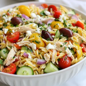 To make Greek Orzo Salad with Chicken, gather these fresh ingredients: - 1 cup orzo pasta - 1 cup cooked chicken breast, shredded - 1 cup cherry tomatoes, halved - 1 cucumber, diced - 1/2 red onion, finely chopped - 1/2 cup Kalamata olives, pitted and halved - 1/2 cup feta cheese, crumbled - 1/4 cup fresh parsley, chopped - 3 tablespoons extra virgin olive oil - 2 tablespoons lemon juice - 1 teaspoon dried oregano - Salt and pepper to taste For added flair, consider these garnishes: - Extra chopped parsley - More crumbled feta cheese - Lemon wedges This salad is not only tasty but also healthy. Each serving has: - Calories: approximately 350 - Protein: 25 grams - Carbohydrates: 30 grams - Fat: 15 grams - Fiber: 3 grams {{ingredient_image_1}} Start by boiling water in a large pot. Add one cup of orzo pasta once the water boils. Cook it according to the package instructions. You want it to be al dente. This means it should be firm but not hard. After cooking, drain the orzo. Rinse it under cold water to stop the cooking process. This step keeps the pasta from getting mushy. Set it aside while you prepare the other ingredients. In a large mixing bowl, combine your salad ingredients. First, add the cooled orzo. Then, mix in one cup of shredded cooked chicken breast. Next, add one cup of halved cherry tomatoes. Dice one cucumber and toss that in too. Finely chop half of a red onion and add it to the bowl. Now, add half a cup of Kalamata olives. Finally, sprinkle in half a cup of crumbled feta cheese. This mix creates a colorful and tasty salad. Grab a small bowl for the dressing. Whisk together three tablespoons of extra virgin olive oil and two tablespoons of lemon juice. Add one teaspoon of dried oregano. Season with salt and pepper to taste. Whisk until the dressing is well blended. This dressing adds a bright flavor to the salad. Pour it over the pasta and chicken mixture in your large bowl. Gently toss everything together until well coated. Chilling your Greek orzo salad is key. After mixing, let it sit in the fridge for at least 30 minutes. This time allows the flavors to blend. The salad tastes fresher and more vibrant after chilling. Plus, the cool salad is perfect on a hot day. Always taste your salad before serving. If it needs more flavor, add salt and pepper. You can also add more lemon juice for extra zing. Each ingredient brings its own taste. Adjust them to fit your preference. Remember, seasoning makes your dish shine. Presentation matters! Serve the salad in a large, colorful bowl. Top it with extra parsley and a sprinkle of feta. For individual servings, use wide bowls. This way, each person sees all the bright colors. A beautiful dish makes it more inviting and fun to eat. Pro Tips Chill for Flavor: Allow the salad to sit in the refrigerator for at least 30 minutes before serving to enhance and meld the flavors. Fresh Ingredients Matter: Use fresh vegetables and herbs to maximize the taste and nutritional value of your salad. Customize Your Protein: Feel free to substitute the chicken with grilled shrimp or chickpeas for a different protein option. Dress Just Before Serving: If preparing in advance, keep the dressing separate until just before serving to maintain the pasta's texture and prevent sogginess. {{image_2}} You can easily make this salad vegan. Start by swapping the chicken for chickpeas or tofu. Both options add protein and a nice texture. Instead of feta cheese, use a vegan feta or skip it altogether. This keeps the salad fresh and tasty while meeting vegan needs. If you want more protein, consider adding shrimp or grilled fish. Both pair nicely with the flavors in this salad. You can even mix in some beans like black beans or white beans for extra fiber. Each option adds a new layer of taste and nutrition. Change the salad with seasonal ingredients. In summer, add bell peppers or zucchini for crunch. In fall, roasted sweet potatoes or butternut squash add warmth and flavor. You can also swap cherry tomatoes for diced heirloom tomatoes when they are in season for a richer taste. These changes keep your salad exciting all year. To keep your Greek Orzo Salad fresh, place it in an airtight container. Make sure the salad cools down first. This helps avoid moisture buildup, which can make the salad soggy. You can store it in the fridge for a quick meal later. When you want to eat the salad again, you can enjoy it cold. If you prefer it warm, gently heat the salad in a pan over low heat. Stir it often to ensure even warming. Avoid using the microwave, as it can make the orzo too mushy. Greek Orzo Salad stays fresh in the fridge for about 3 to 5 days. Make sure to check for any signs of spoilage. If the salad smells off or has changed color, it’s best to toss it. Enjoy your salad often, but remember to keep it safe! Yes, you can use other pasta types. If you want a gluten-free option, try rice pasta. For a heartier bite, choose penne or fusilli. Each pasta type gives a different taste and texture. Just make sure to cook it until al dente. This keeps it firm in the salad. You can store Greek Orzo Salad in the fridge for up to three days. Make sure to keep it in an airtight container. This helps keep the flavors fresh. After a day, you might need to add a dash of lemon juice or olive oil. This keeps the salad from getting dry. Serve the salad chilled for a refreshing taste. Use a large bowl to show off the colors. Garnish with extra parsley and a bit of feta on top. If serving guests, offer individual bowls to make it special. Pair this salad with grilled meats or as a light meal on its own. This article covered the ingredients and steps needed to make Greek Orzo Salad. We discussed tips for flavor, variations, and proper storage. The options for customization allow you to create a dish that suits your taste. Always remember to chill the salad to boost flavor. With easy adjustments and simple storage tips, this salad can be a go-to meal for any occasion. Enjoy making your own flavorful Greek Orzo Salad!