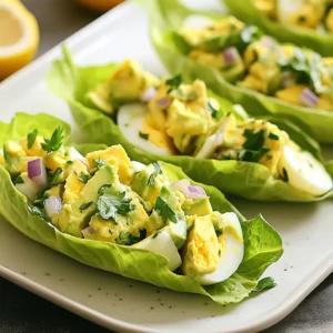 - 4 hard-boiled eggs, peeled and chopped - 1 ripe avocado, pitted and mashed - 2 tablespoons Greek yogurt - 1 tablespoon Dijon mustard - 1 tablespoon lemon juice - 1 small red onion, finely chopped - 1 celery stalk, finely diced - Salt and pepper to taste - 1 head of romaine lettuce (for wraps) - Fresh parsley, chopped The avocado egg salad is creamy and full of flavor. The hard-boiled eggs give it protein. The avocado adds healthy fats and a nice texture. Mixing in Greek yogurt makes it rich and tangy. Dijon mustard brings a sharp taste that lifts the dish. Lemon juice adds brightness and keeps the avocado fresh. The red onion and celery give crunch and color. For the wraps, romaine lettuce is perfect. It is sturdy and crisp. You can use other leafy greens too, but romaine holds up well. Garnishes like fresh parsley add a nice touch. They make the dish look vibrant and inviting. You can sprinkle them on top for added flavor. {{ingredient_image_1}} Start by hard-boiling four eggs. Place them in a pot, cover with water, and bring to a boil. Once boiling, reduce heat and simmer for 10-12 minutes. When done, cool them in ice water. Peel and chop the eggs when they are cool. Next, grab a ripe avocado. Cut it in half, remove the pit, and scoop the flesh into a bowl. Mash it well with a fork until smooth. In a mixing bowl, combine the chopped eggs and mashed avocado. Add two tablespoons of Greek yogurt, one tablespoon of Dijon mustard, and one tablespoon of lemon juice. Mix these ingredients together until they are creamy and well blended. Then, finely chop one small red onion and dice one celery stalk. Stir these into the egg salad mixture. Season with salt and pepper to your taste. Adjust as needed for flavor. Now, take a head of romaine lettuce. Carefully separate the leaves, wash them under cold water, and pat them dry. This will be your wrap. Spoon a generous amount of the avocado egg salad into each lettuce leaf. Aim for a nice, full wrap. Finally, garnish with freshly chopped parsley for color and flavor. For a nice touch, arrange the wraps on a platter with the open side facing up. Serve with lemon wedges for a fresh squeeze while eating. To get the best mashed avocado, use a fork. Press down firmly but gently. You want it smooth, not pureed. A ripe avocado makes this easier. Look for one that gives slightly when you press it. If you prefer a chunky texture, stop mashing sooner. For a creamy avocado egg salad, add Greek yogurt. This gives it a nice tang and moisture. You can also mix in some Dijon mustard for extra flavor. The lemon juice helps keep the color bright and fresh. Adjust the amount based on your taste. You can change the flavor of your egg salad easily. Add herbs like dill or chives for a fresh taste. If you like spice, stir in some diced jalapeños. For a sweet note, try adding diced apples or grapes. Always taste as you mix to get it just right. Pro Tips Use Fresh Ingredients: Always select ripe avocados and fresh vegetables to enhance the flavors of your egg salad. Customize Your Seasoning: Feel free to add spices like paprika or cayenne pepper for an extra kick in flavor. Make It Ahead: You can prepare the egg salad a few hours in advance; just store it in the refrigerator until ready to serve. Experiment with Greens: Try using other leafy greens like butter lettuce or kale for different textures and flavors. {{image_2}} You can change the lettuce to mix things up. Try using butter lettuce for a soft bite. It wraps well and adds a silky texture. You can also use collard greens for a sturdier wrap. They hold up great and have a nice, earthy flavor. If you want a crunch, use cabbage leaves. They add a fun texture to your meal. Want to make this dish vegan? Swap out the eggs and yogurt. Use chickpeas instead of eggs. Mash them up for a similar texture. For creaminess, try using silken tofu or mashed avocado. These give a rich taste without dairy. You can add nutritional yeast for a cheesy flavor. Feel free to get creative with mix-ins. Diced bell peppers add sweetness and color. Chopped pickles or relish bring a nice tang. You can also add spices like paprika or curry powder for extra flavor. Fresh herbs like dill or cilantro brighten the dish. Just remember to mix well for even flavor distribution. You can keep leftover egg salad in the fridge. Use an airtight container. It stays fresh for up to three days. When you want to eat it, check for any odd smells. If it smells fine, mix it well before serving. Freezing egg salad is not the best idea. The texture changes when it thaws. If you have to freeze it, use a freezer-safe bag. Squeeze out all the air before sealing. Use it within a month for best taste. Store lettuce wraps in the fridge for up to a day. Keep the filling and lettuce separate. This keeps the wraps crisp and fresh. If you have leftover filling, use it in a salad or on toast. Avocado Egg Salad Lettuce Wraps are best when fresh. If stored, they can last for about 1 to 2 days in the fridge. The key is to keep the salad and lettuce separate until you serve them. This helps keep the lettuce crisp and the salad fresh. If you mix them, the lettuce wilts quickly. Yes, you can use different types of lettuce! While romaine is great, you can try butter lettuce or iceberg for a crunchy bite. Each type adds its own flavor and texture. Just make sure the leaves are large enough to hold the filling. Many options go well with these wraps. You can serve them with fresh fruit for a light meal. Chips or crackers add a nice crunch. You might also enjoy a simple soup on the side. These pairings make the meal more filling and fun! This blog post covered how to make delicious avocado egg salad lettuce wraps. We discussed key ingredients, step-by-step instructions, and tips for the best flavor. You learned about variations and how to store leftovers. My final thought is that this dish is easy to make and very tasty. Feel free to customize it to your liking. Enjoy your healthy meals!