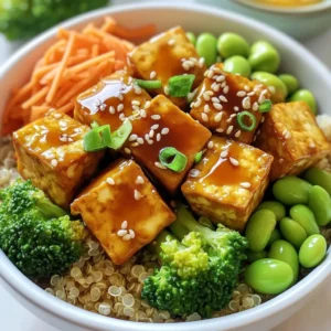 To create Teriyaki Tofu Power Bowls, you need a few key ingredients: - 1 block (14 oz) firm tofu, drained and pressed - 1/4 cup soy sauce (or tamari for gluten-free) - 2 tablespoons maple syrup - 1 tablespoon rice vinegar - 1 tablespoon sesame oil - 1 tablespoon cornstarch - 2 cups cooked quinoa or brown rice - 1 cup steamed broccoli florets - 1 cup shredded carrots - 1 cup edamame, shelled - 2 green onions, sliced - Sesame seeds for garnish - Sriracha for serving (optional) These ingredients combine to create a tasty and healthy meal. The firm tofu gives the dish a great texture. The quinoa or brown rice serves as a strong base. The veggies add freshness and crunch. You can customize your bowls with different toppings. Try adding: - Sliced avocado for creaminess - Cucumber for a refreshing crunch - Red cabbage for a pop of color - Peanuts or cashews for extra crunch These additions make the meal even more vibrant and fun. You can mix and match these toppings based on what you have or what you love. Not all tofu is created equal. For the best results, choose high-quality brands. Some trusted names include: - Nasoya - Wildwood - Mori-Nu These brands offer firm tofu that holds up well during cooking. Quality tofu makes a big difference in taste and texture. Always check for freshness and choose organic options when possible for a healthier meal. {{ingredient_image_1}} To start, you need to press the tofu. This step is key. Pressing removes extra moisture, which helps the tofu get crispy. Wrap the block of tofu in a clean kitchen towel. Place a heavy skillet on top. Let it sit for 10 to 15 minutes. After pressing, the tofu should feel firmer and drier. While the tofu presses, make the teriyaki sauce. In a small bowl, mix together the soy sauce, maple syrup, rice vinegar, and sesame oil. This sauce brings a sweet and savory flavor. Make sure to stir well until all the ingredients combine. It should smell amazing already! Now, it’s time to cook the tofu. Cut the pressed tofu into bite-sized cubes for easy eating. Toss these cubes in cornstarch. This step helps the tofu crisp up beautifully. Heat a small amount of oil in a large skillet over medium-high heat. Add the tofu cubes to the skillet. Cook each side for about 3 to 4 minutes. Look for a golden-brown color. This shows it is crispy and ready. Once the tofu is crispy, pour the teriyaki sauce over the tofu in the skillet. Stir to coat the tofu evenly. Let it cook for another 2 to 3 minutes. This allows the sauce to thicken slightly. Now, it's time to build your power bowl. Start with a layer of cooked quinoa or brown rice at the bottom of the bowl. Top with steamed broccoli, shredded carrots, and edamame. Finally, add the teriyaki tofu on top. Garnish with sliced green onions and sprinkle sesame seeds for a nice touch. If you like heat, serve with Sriracha on the side. Enjoy your colorful and tasty meal! Pressing tofu is key to a great texture. Start by wrapping the tofu block in a clean kitchen towel. Place a heavy skillet on top. Let it sit for 10-15 minutes. This step removes excess moisture and helps the tofu absorb flavors. Don't skip this! For perfect quinoa, use a 2:1 water-to-quinoa ratio. Rinse the quinoa before cooking to remove bitterness. Bring water to a boil, add the quinoa, cover, and simmer for 15 minutes. For brown rice, use a 2.5:1 water-to-rice ratio. Simmer for about 45 minutes. Let it sit after cooking to fluff it up. To achieve the right sauce thickness, cook it gently. Mix soy sauce, maple syrup, rice vinegar, and sesame oil in a bowl. When you add it to the tofu, let it simmer for 2-3 minutes. This helps the sauce thicken. If it's too thin, add a little more cornstarch mixed with water. This trick will give you a glossy, rich sauce that clings perfectly to the tofu. Pro Tips Press the Tofu Thoroughly: Ensure you press the tofu well to remove as much moisture as possible. This helps achieve a crispy texture when cooked. Customize the Sauce: Feel free to adjust the teriyaki sauce ingredients according to your taste. Add more maple syrup for sweetness or a splash of ginger for added flavor. Use Fresh Vegetables: For the best taste and nutrition, use fresh, seasonal vegetables in your power bowl. They add vibrant color and crunch. Meal Prep Friendly: This recipe is perfect for meal prep! Cook extra tofu and grains to have on hand for quick lunches or dinners throughout the week. {{image_2}} If you want to switch up the protein, there are great choices for vegetarians and vegans. You can use tempeh, which has a nutty flavor and firm texture. Seitan is another option; it mimics meat well and absorbs flavors nicely. For a lighter choice, consider chickpeas or lentils. Both add protein and fiber. In your Teriyaki Tofu Power Bowls, you can mix in various vegetables. Bell peppers add sweetness and crunch. Snap peas bring a fresh bite. Zucchini or mushrooms can also enhance the taste. Feel free to add kale or spinach for more greens. The mix of colors and textures will make the dish visually appealing and nutritious. To keep your meal gluten-free, choose tamari instead of soy sauce. This helps avoid gluten while keeping the flavor. Cornstarch is already gluten-free, so it works perfectly for the tofu. You can also use rice or quinoa as your base, both of which are gluten-free. Always check your ingredient labels to ensure they meet your dietary needs. To keep your Teriyaki Tofu Power Bowls fresh, store them in an airtight container. Let the dish cool to room temperature first. Once cooled, divide the bowls into serving sizes. Place them in the fridge for up to three days. This method keeps the flavors intact and prevents sogginess. When you are ready to eat, reheat the bowls gently. Use a microwave or a skillet. If using a microwave, heat in short bursts of 30 seconds. Stir between each burst for even heating. If using a skillet, add a splash of water to keep the tofu moist. Heat on low until warmed through. This keeps the tofu crispy and the veggies tender. If you want to save some bowls for later, freezing is an option. However, the texture of the tofu may change after freezing. To freeze, pack the bowls in airtight containers. Remove as much air as possible. You can freeze them for up to a month. To thaw, place them in the fridge overnight before reheating. This helps maintain flavor and quality. Soy sauce and tamari both add flavor to dishes, but they differ in ingredients. Soy sauce contains wheat, while tamari is usually gluten-free. Tamari has a richer taste and is thicker. If you want a gluten-free option, use tamari in your teriyaki sauce. Yes, you can use other proteins. Chicken, beef, or shrimp work well in this dish. Just adjust the cooking time based on the protein you choose. You can also try tempeh or seitan for a plant-based option. To add spice, use Sriracha or chili paste. You can mix it into the teriyaki sauce for a kick. Garnish with sliced jalapeños or add red pepper flakes for extra heat. Adjust the amount based on your heat preference. Teriyaki Tofu Power Bowls offer many health benefits. Tofu is high in protein and contains all nine essential amino acids. Quinoa or brown rice provides fiber and energy. The vegetables add vitamins, minerals, and antioxidants. This meal is balanced, tasty, and filling. In this post, we explored how to make Teriyaki Tofu Power Bowls. We covered the main and optional ingredients, like high-quality tofu brands. You learned step-by-step how to prepare tofu, make teriyaki sauce, and assemble the bowls. We shared tips for pressing tofu and cooking grains. We also discussed variations for dietary needs and how to store leftovers. Now, you can enjoy a delicious, healthy meal any time. This dish is not only tasty but also easy to make!