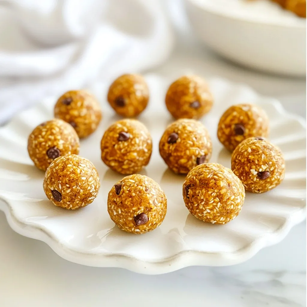 To make these tasty pumpkin spice energy balls, gather these items: - 1 cup rolled oats - 1/2 cup nut butter (such as almond or peanut) - 1/2 cup pumpkin puree - 1/4 cup honey or maple syrup - 1 teaspoon vanilla extract - 1 teaspoon pumpkin spice blend (or a mix of cinnamon, nutmeg, and ginger) - 1/4 teaspoon salt - 1/2 cup mini chocolate chips (optional) - 1/4 cup flaxseeds or chia seeds If you can’t use nut butter, try these options: - Sunflower seed butter - Soy nut butter - Pumpkin seed butter These choices work well and add great flavor. Pumpkin puree makes this snack special. It adds moisture and flavor. It is rich in vitamins A and C. These vitamins help keep your eyes and skin healthy. Pumpkin also has fiber, which aids digestion. It can keep you full longer. Plus, it gives these energy balls a lovely color and taste. {{ingredient_image_1}} Start by grabbing a large mixing bowl. Add 1 cup of rolled oats. Then, scoop in 1/2 cup of nut butter. You can choose almond or peanut butter. Next, add 1/2 cup of pumpkin puree. Pour in 1/4 cup of honey or maple syrup for sweetness. Lastly, add 1 teaspoon of vanilla extract. Mix all these ingredients well until they blend smoothly. This step forms the base of your energy balls. After mixing the base, it’s time to spice things up. Add 1 teaspoon of pumpkin spice blend. If you don’t have that, a mix of cinnamon, nutmeg, and ginger works great. Then, sprinkle in 1/4 teaspoon of salt. Stir until the spices are fully mixed in. If you want some extra fun, fold in 1/2 cup of mini chocolate chips. You can also add 1/4 cup of flaxseeds or chia seeds. These add nutrients and texture. Now comes the fun part—shaping the balls! With clean hands, take a small amount of the mixture. Form it into a ball about 1 inch in diameter. Place each ball on a baking sheet lined with parchment paper. Once you shape all the mixture into balls, it’s chilling time. Refrigerate the balls for at least 30 minutes. This helps them firm up. After chilling, they’re ready to enjoy or store. Keep them in an airtight container in the fridge for up to one week. To get the right texture, use rolled oats. They give a nice chew. If the mix feels too wet, add more oats. If it’s too dry, add a splash of nut butter or pumpkin puree. After mixing, roll the balls tightly. This helps them hold their shape. Chilling them in the fridge for 30 minutes helps too. It firms them up nicely. These energy balls make great snacks. Serve them at parties or pack them for lunch. They pair well with apple slices or yogurt. You can also drizzle a bit of honey on top for extra sweetness. If you want fun, place them in cute cups for a treat display. Don’t skip the chilling step. This keeps the balls from falling apart. Be careful not to overmix the ingredients. If you mix too much, the texture can turn mushy. Also, watch your portion size. Making them too big can make them hard to eat. Finally, remember to store them in an airtight container to keep them fresh. Pro Tips Use Fresh Pumpkin Puree: For the best flavor, use fresh pumpkin puree instead of canned. Roast and puree your own pumpkin for a richer taste. Customize Your Sweetness: Adjust the amount of honey or maple syrup to your taste. If you prefer a less sweet treat, reduce the sweetener by a tablespoon or two. Add Protein: Enhance the nutritional value by incorporating protein powder into the mixture. This can make them a more filling snack. Experiment with Mix-ins: Feel free to customize these energy balls with your favorite mix-ins, such as dried fruits, nuts, or seeds for added texture and flavor. {{image_2}} To mix things up, you can add flavor twists. If you love chocolate, fold in mini chocolate chips for a sweet burst. You can also use protein powder for a boost. Just replace some oats with protein powder. This adds flavor and makes them more filling. If you need nut-free options, try sunflower seed butter. It offers a creamy texture and rich taste. You can also use pumpkin seeds instead of nut butter. This keeps the snack safe for schools or nut-free diets. You can give your energy balls a seasonal flair. Adding dried cranberries gives a tart kick. Chopped apples or pears add freshness, too. In winter, try adding a touch of peppermint or nutmeg for a holiday vibe. To keep your pumpkin spice energy balls fresh, store them in an airtight container. Place a piece of parchment paper between layers to prevent sticking. Keep them in the fridge for the best taste and texture. This method helps maintain their chewy goodness. You can freeze your energy balls for longer storage. First, place them in a single layer on a baking sheet. Freeze for about one hour until firm. Then, transfer them to a freezer-safe bag. Be sure to remove as much air as possible. They will stay fresh this way for up to three months. These energy balls last about a week in the fridge. For the best flavor, eat them within this time. If you freeze them, they can last longer. Always check for signs of spoilage, like an off smell or change in color. Trust your senses to keep your snacks safe and tasty! Yes, you can make these energy balls vegan. Use maple syrup instead of honey. Choose a nut butter that has no added ingredients. Most nut butters are vegan. For the chocolate chips, pick dairy-free ones. This way, you keep the taste and texture while being vegan. Yes, pumpkin spice energy balls are healthy. They include rolled oats, which are high in fiber. Pumpkin puree adds vitamins and minerals. Nut butter provides healthy fats and protein. Honey or maple syrup gives natural sweetness. These energy balls keep you full and fueled. These energy balls last for up to one week in the fridge. Store them in an airtight container. For longer storage, you can freeze them. They can last for about three months in the freezer, so you have a tasty snack ready. Yes, you can add other ingredients! Chopped nuts add crunch and flavor. Try walnuts or pecans for a tasty twist. You can also mix in seeds like sunflower or pumpkin seeds for extra nutrition. Just keep the overall balance in mind. You now have all the tools to make delicious energy balls. We've covered ingredients, including nut butter substitutes and the benefits of pumpkin puree. You learned the step-by-step process for mixing and chilling them. I shared tips for texture, serving, and common mistakes to avoid. We explored flavor variations and storage methods. With this guide, you can create tasty snacks that fit your needs. Embrace creativity, enjoy the process, and savor the rewards of your effort.