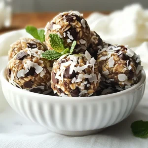 To make these tasty Mint Chocolate Chip Energy Bites, you will need: - 1 cup rolled oats - 1/2 cup almond butter (or any nut/seed butter) - 1/4 cup honey or maple syrup - 1/4 cup mini dark chocolate chips - 1/4 cup shredded coconut (unsweetened) - 1 teaspoon pure peppermint extract - 1 tablespoon chia seeds - A pinch of salt You can change some ingredients if needed. Here are some great swaps: - Use peanut butter instead of almond butter. - Maple syrup works well instead of honey. - Try any nut or seed butter you like. - Use regular chocolate chips if you prefer. - For a nut-free option, choose sunflower seed butter. These options keep the bites tasty while fitting your needs. Each serving has about 1-2 energy bites. Here’s a rough estimate for one bite: - Calories: 90 - Protein: 2g - Carbohydrates: 10g - Fat: 5g - Fiber: 2g - Sugar: 4g This snack offers a good mix of energy and nutrients. Enjoy the burst of flavor while fueling your day! {{ingredient_image_1}} To make mint chocolate chip energy bites, start by gathering your ingredients. You need: - 1 cup rolled oats - 1/2 cup almond butter (or any nut/seed butter) - 1/4 cup honey or maple syrup - 1/4 cup mini dark chocolate chips - 1/4 cup shredded coconut (unsweetened) - 1 teaspoon pure peppermint extract - 1 tablespoon chia seeds - A pinch of salt In a large bowl, mix the rolled oats, almond butter, honey (or maple syrup), and peppermint extract. Stir until everything combines well. Next, add the mini dark chocolate chips, shredded coconut, chia seeds, and salt. Use your hands or a spatula to mix it all together until it's fully combined. When rolling the mixture into small balls, aim for about 1 inch in size. If the mixture feels too sticky, wet your hands with a little water. This helps the mixture come together nicely. Try to make them uniform in size, so they look great when served. After rolling the bites, place them on a parchment-lined baking sheet. Refrigerate them for at least 30 minutes. This helps them firm up and stay together. For serving, consider using a decorative bowl or platter. You can add fresh mint leaves for a nice touch. Enjoy these bites as a quick snack or a fun treat! To get a great texture in your energy bites, you need balance. Use rolled oats for chewiness. Almond butter adds creaminess. If the mix feels too dry, add a bit more honey. If it’s too sticky, add more oats. Aim for a dough that holds its shape when you roll it. Store your energy bites in an airtight container. This keeps them fresh. They can last up to one week in the fridge. For longer storage, freeze them. Just place them in a single layer on a baking sheet first. Once frozen, you can put them in a bag. They will last for about three months in the freezer. To impress your guests, serve the bites in a pretty bowl. Add fresh mint leaves for color. You can also drizzle some melted dark chocolate over them. This adds a nice touch and makes them look fancy. For a fun party snack, arrange them on a platter with fruits. Everyone will love them! Pro Tips Use Fresh Ingredients: For the best flavor, use fresh mint leaves as a garnish along with your energy bites. Customize Sweetness: Adjust the amount of honey or maple syrup to your taste; consider reducing it for a less sweet treat. Experiment with Mix-ins: Feel free to add nuts, seeds, or dried fruits to enhance the texture and flavor of your energy bites. Chill for Firmness: Ensure to chill the energy bites for at least 30 minutes before serving; this helps them hold their shape better. {{image_2}} You can play with flavors for your Mint Chocolate Chip Energy Bites. Here are some ideas: - Coconut Lime: Swap the peppermint for lime juice and zest. - Peanut Butter Chocolate: Change almond butter to peanut butter. Keep the chocolate chips. - Matcha Mint: Add matcha powder for a green twist. Reduce peppermint a bit. - Chocolate Coconut: Use cocoa powder instead of peppermint extract. Add extra chocolate chips. Each variation provides a unique taste that keeps things fresh and fun. If you have allergies, you can still enjoy these bites. Here are some swaps: - Nut-Free: Use sunflower seed butter instead of almond butter. - Gluten-Free: Make sure to use certified gluten-free oats. - Vegan: Use maple syrup and a plant-based butter. - Dairy-Free: Stick to dark chocolate chips that are dairy-free. These changes ensure everyone can enjoy these tasty bites. Why not boost your energy bites with superfoods? Here are some ideas: - Chia Seeds: You already use them! They add fiber and protein. - Flaxseeds: Add ground flaxseeds for omega-3s. - Hemp Seeds: Toss in hemp seeds for extra protein and crunch. - Spirulina: Add a small amount of spirulina for a nutrient boost. Superfoods not only enhance nutrition but also add interesting textures and flavors. To keep your Mint Chocolate Chip Energy Bites fresh, store them in an airtight container. Place them in the refrigerator to maintain their taste and texture. They stay good for about one week. If you notice any moisture, dry them off with a paper towel. This helps prevent sogginess. If you want to store the energy bites for a longer time, freezing is a great option. Place them in a single layer on a baking sheet. Freeze for about one hour until firm. Then, transfer them to a freezer-safe bag or container. This way, they can last up to three months. When you're ready to eat, thaw them in the fridge overnight. You might have some ingredients left over. Use any extra almond butter in smoothies or spread it on toast. Leftover shredded coconut can top yogurt or oatmeal. Chia seeds are great in puddings or added to salads. These ideas help reduce waste and keep your pantry stocked with tasty options. Mint chocolate chip energy bites last up to one week in the fridge. Store them in an airtight container for best results. After a week, they may lose freshness. If you want to enjoy them longer, consider freezing them. They will stay good for about three months in the freezer. Just thaw them before eating. Yes, you can use other nut or seed butters. Almond butter is popular, but peanut butter works well, too. Sunflower seed butter is a great choice for those with nut allergies. Each type adds its unique taste and texture. Feel free to experiment and find your favorite! Absolutely! These energy bites are a great snack for kids. They are tasty, healthy, and easy to eat. The mini chocolate chips make them fun and appealing. Plus, they provide energy from oats and healthy fats from nut butter. Just keep an eye on portion sizes for younger kids. This blog post covered key steps to make Mint Chocolate Chip Energy Bites. We explored ingredients and their substitutions. Next, we provided clear instructions to mix and chill your bites. Helpful tips helped with texture and storage. We shared fun variations and answered common questions for clarity. These energy bites are easy, tasty, and fun. Enjoy making them your own!