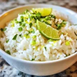 To make coconut lime rice, you'll need some simple, fresh ingredients. Here’s what you need: - 1 cup jasmine rice - 1 cup coconut milk - 1/2 cup water - Zest of 1 lime - Juice of 1 lime - 1 tablespoon sugar (optional) - 1/2 teaspoon salt - Fresh cilantro or green onions for garnish Each of these ingredients plays a big role. The jasmine rice gives a lovely texture and aroma. Coconut milk adds rich creaminess, while lime brings a bright, zesty flavor. You can choose to add sugar for sweetness, but it’s up to your taste. The salt helps balance all the flavors. Fresh cilantro or green onions make a great finishing touch for color and freshness. Gather these items, and you're ready to create a delightful side dish! {{ingredient_image_1}} - First, rinse the jasmine rice under cold water until the water runs clear. This step removes the extra starch. - Next, combine the rinsed rice in a medium saucepan with coconut milk, water, lime zest, lime juice, sugar (if you want it), and salt. - Now, bring the mixture to a gentle boil over medium heat. - Once it starts boiling, reduce the heat to low. Cover it and let it simmer for about 15-20 minutes. You want the rice to absorb all the liquid and become tender. - After cooking, remove the saucepan from the heat. Let it sit, still covered, for an additional 5 minutes. This helps the rice steam and fluff up. - Finally, fluff the rice gently with a fork. Taste it and adjust the sweetness or salt if needed. For coconut lime rice, I always use jasmine rice. This rice has a sweet flavor and a soft texture. It cooks well and absorbs the coconut milk nicely. If you want to try something new, you can use basmati or brown rice. Basmati adds a nutty taste, while brown rice gives more fiber. You can adjust the sweetness and salt levels to your taste. If you like it sweeter, add more sugar. If you prefer it saltier, add a pinch more salt. You can also add spices or herbs. A bit of garlic or ginger can add warmth. Fresh herbs like cilantro or mint bring brightness to your rice. Coconut lime rice pairs well with many main dishes. It goes great with grilled chicken, fish, or shrimp. You can also serve it with veggie curries or stir-fries. For garnishes, I like to use fresh cilantro or green onions. Toasted coconut flakes add a nice crunch, too. Pro Tips Rinse the Rice: Always rinse jasmine rice under cold water until the water runs clear to remove excess starch, which helps prevent the rice from becoming gummy. Adjusting Sweetness: The sugar in the recipe is optional; taste the rice after cooking and adjust sweetness according to your preference. Steaming for Fluffiness: Letting the rice sit covered after cooking allows it to steam, making it fluffier and enhancing the texture. Garnish for Freshness: Garnishing with fresh cilantro or green onions not only adds color but also enhances the flavor profile of the dish. {{image_2}} You can make tropical coconut lime rice by adding fresh fruit. Pineapple or mango adds sweetness and zest. Chop them into small pieces and stir them in before serving. You can also use different citrus fruits. Try orange or lemon for a new twist. For a kick, add chili or jalapeños to your rice. This gives it a nice heat. Start with a small amount and taste as you go. Balance the heat with sweetness by adding a bit more sugar. This contrast makes the dish exciting and fun. To keep it vegetarian or vegan, skip any animal products. Use coconut milk and water, which are both plant-based. Coconut lime rice pairs well with plant-based dishes. Try it with grilled vegetables or tofu for a complete meal. To keep your coconut lime rice fresh, use airtight containers. Glass or plastic containers work well. Let the rice cool to room temperature before sealing. Store it in the fridge for up to four days. Label your container with the date to track freshness. The best way to reheat coconut lime rice is on the stove. Add a splash of water or coconut milk in a non-stick pan. Heat over low to medium heat, stirring often. This helps keep the rice moist and tasty. You can also microwave it. Use a covered dish and add a little water. Heat in short bursts, checking often. To freeze coconut lime rice, let it cool completely first. Place it in a freezer-safe bag or container. Flatten the bag to save space. You can freeze it for up to three months. When you're ready to eat, thaw it overnight in the fridge. Reheat it on the stove or microwave as mentioned before for the best results. You can pair Coconut Lime Rice with many dishes. Here are some tasty options: - Grilled chicken or shrimp for a light meal. - Spicy curries to balance the flavors. - Stir-fried vegetables for a healthy side. - Fish tacos for a fun twist. - Black beans for extra protein and taste. These options complement the sweet and zesty notes of the rice. Yes, you can use other rice types. Jasmine rice is special for its aroma and texture. Other options like basmati or long-grain rice can work, but they may change the flavor slightly. Jasmine rice cooks fluffy and absorbs flavors well. If you use brown rice, remember it takes longer to cook. Adjust the liquid and cooking time as needed for the best results. To make Coconut Lime Rice creamier, try these tips: - Use more coconut milk and less water. - Stir in a spoonful of butter or cream after cooking. - Add a splash of coconut cream for richness. - Mix in some shredded coconut for texture. These tips will give you a deliciously creamy texture. Enjoy your cooking! Coconut lime rice is simple to make and so tasty. You need just a few main ingredients. Follow the steps to cook jasmine rice perfectly. I shared tips on enhancing flavors and serving ideas. You can even try fun variations for a twist. This dish works well for any meal. Enjoy experimenting with your own touches to make it your own.