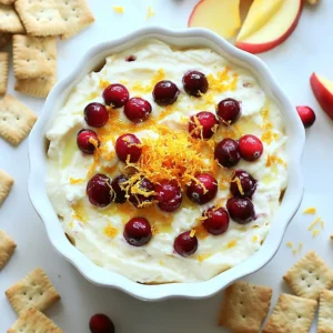 - 8 oz cream cheese, softened - 1/2 cup sour cream - 1/4 cup powdered sugar To make the base of the dip, cream cheese is key. Use softened cream cheese for the best texture. It gives the dip a smooth and rich feel. The sour cream adds a nice tang. It balances the sweetness from the powdered sugar. This sweet touch helps round out the flavors. - 1 teaspoon vanilla extract - Zest of 1 orange - 1/2 cup fresh or frozen cranberries, chopped To boost the flavor, we need a few extras. The vanilla extract brings warmth and depth to the dip. Orange zest gives it a bright, citrusy kick. The chopped cranberries add a pop of color and tartness. These flavors mix well to create a fun twist on cheesecake. - Graham crackers - Apple slices - Pretzels For dipping, you have great choices! Graham crackers are sweet and crunchy, perfect for this creamy dip. Apple slices add a fresh and crisp texture. They pair nicely with the rich flavors. Pretzels offer a salty contrast, making every bite exciting. Try all three for a fun tasting experience! {{ingredient_image_1}} To start, gather your mixing bowl. Add 8 ounces of softened cream cheese. Then, mix in 1/2 cup of sour cream. Next, add 1/4 cup of powdered sugar. Don't forget the teaspoon of vanilla extract. Use an electric mixer on medium speed for about 2-3 minutes. You want a smooth and creamy texture. Now it's time to add some bright flavor! Grate the zest from one orange into the bowl. Then, squeeze in 1/4 cup of fresh orange juice. Mix everything again until the flavors blend well. This step makes the dip taste fresh and exciting. Next, fold in 1/2 cup of chopped cranberries. Sprinkle in 1/4 teaspoon of cinnamon for warmth. Use a spatula to gently combine everything. This helps keep the chunks of cranberries intact. Once mixed, transfer the dip to a serving bowl. Cover it and refrigerate for at least 30 minutes. This chilling time lets the flavors meld together. Before you serve, stir the dip again. If you want it sweeter, add more powdered sugar. To get the right consistency, mix the cream cheese until it's smooth. You want it creamy but not runny. If it&rsquo;s too thick, add a bit more orange juice. This will help make it easier to dip. If the dip is too thin, mix in more cream cheese or sour cream. Adjusting sweetness is simple. If you find the dip is not sweet enough, just add more powdered sugar. Taste it after each addition to get it just right. Everyone has their own sweet spot! Serve the dip in a fun bowl. This adds color and charm to your table. Use a mix of dippers like graham crackers, apple slices, or pretzels. Lay them around the bowl for a great look. For a visual touch, sprinkle extra orange zest or a few chopped cranberries on top. This not only looks nice but also hints at the flavors in the dip. You can prepare this dip in advance. Make it up to a day before your event. Just cover it well and chill it in the fridge. This helps the flavors blend and taste even better. When you're ready to serve, take it out and stir it. If it seems thick, add a splash of orange juice. This will bring it back to that perfect creamy texture. Pro Tips Use Room Temperature Ingredients: Allow your cream cheese and sour cream to come to room temperature before mixing to ensure a smooth and creamy dip without lumps. Adjust Sweetness to Taste: After chilling, taste the dip and adjust the sweetness by adding more powdered sugar if necessary, ensuring it suits your preference. Chill for Better Flavor: Refrigerating the dip for at least 30 minutes allows the flavors to meld beautifully, enhancing the overall taste. Experiment with Dippers: While graham crackers are classic, try serving with a variety of dippers like pretzels or fresh fruit to add different textures and flavors. {{image_2}} You can easily change the taste of your dip with spices. Adding nutmeg or ginger gives a warm twist. Just a pinch can make a big difference. Another fun idea is to use flavored cream cheese. You can find options like vanilla or even orange. This change adds new layers of flavor to your dip. Cranberries are great, but other fruits work too. You can swap cranberries for blueberries, raspberries, or strawberries. Each fruit brings its own taste and color. You can also try different citrus fruits. Lemons or limes can bring a zesty kick that pairs well with the creaminess. Think beyond just graham crackers and apple slices. You can try pretzels for a salty crunch. Sliced bananas or even cookies can be fun options. To mix it up, serve with sweet and savory dippers. Cheese crackers or even veggies like celery add a nice contrast to the dip. To keep your cranberry orange cheesecake dip fresh, use an airtight container. Glass containers work well. They help keep the flavors intact. You can also use plastic containers, but ensure they seal tightly. Store the dip in the fridge right after serving. It will stay fresh for up to 3 days. Can you freeze the dip? Yes, you can freeze it! Just place the dip in a freezer-safe container. Leave some space at the top for expansion. This dip can last for up to 2 months in the freezer. When you want to eat it, thaw it in the fridge overnight. After thawing, give it a good stir. It may need some fresh orange juice or sugar to regain its creaminess. Enjoy your dip! Cranberry orange cheesecake dip can sit out for about two hours. After that, bacteria can grow. If it&rsquo;s a warm day, keep it shorter. Try to serve it fresh. If you have leftovers, store them in the fridge right away. Yes, you can use low-fat cream cheese. It will make the dip lighter. However, the dip may not be as rich and creamy. Keep in mind that the texture may change slightly, but the flavors will still shine. You have many fun options for dippers! Here are some ideas: - Graham crackers - Apple slices - Pretzels Each of these adds a unique taste. You can also try: - Vanilla wafers for a sweet crunch. - Fruit skewers for a colorful touch. - Pita chips for a savory twist. For special occasions, use festive plates and fun dippers. This makes the dip look even more appealing. Consider adding a side of whipped cream for extra sweetness. You can also garnish with fresh cranberries or extra orange zest. This adds a nice touch! This blog post shared a simple recipe for cranberry orange cheesecake dip. You learned about essential ingredients like cream cheese and sour cream, plus flavor enhancers such as vanilla and orange zest. We covered step-by-step instructions and tips for perfecting the dip's consistency. You also discovered fun presentation ideas and storage options, along with variations for personal taste. In closing, this dip makes a great snack or dessert. Experiment with flavors and dippers, and have fun sharing it!